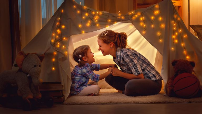 mom and daughter in blanket fort